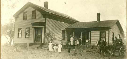 Family standing in front of home