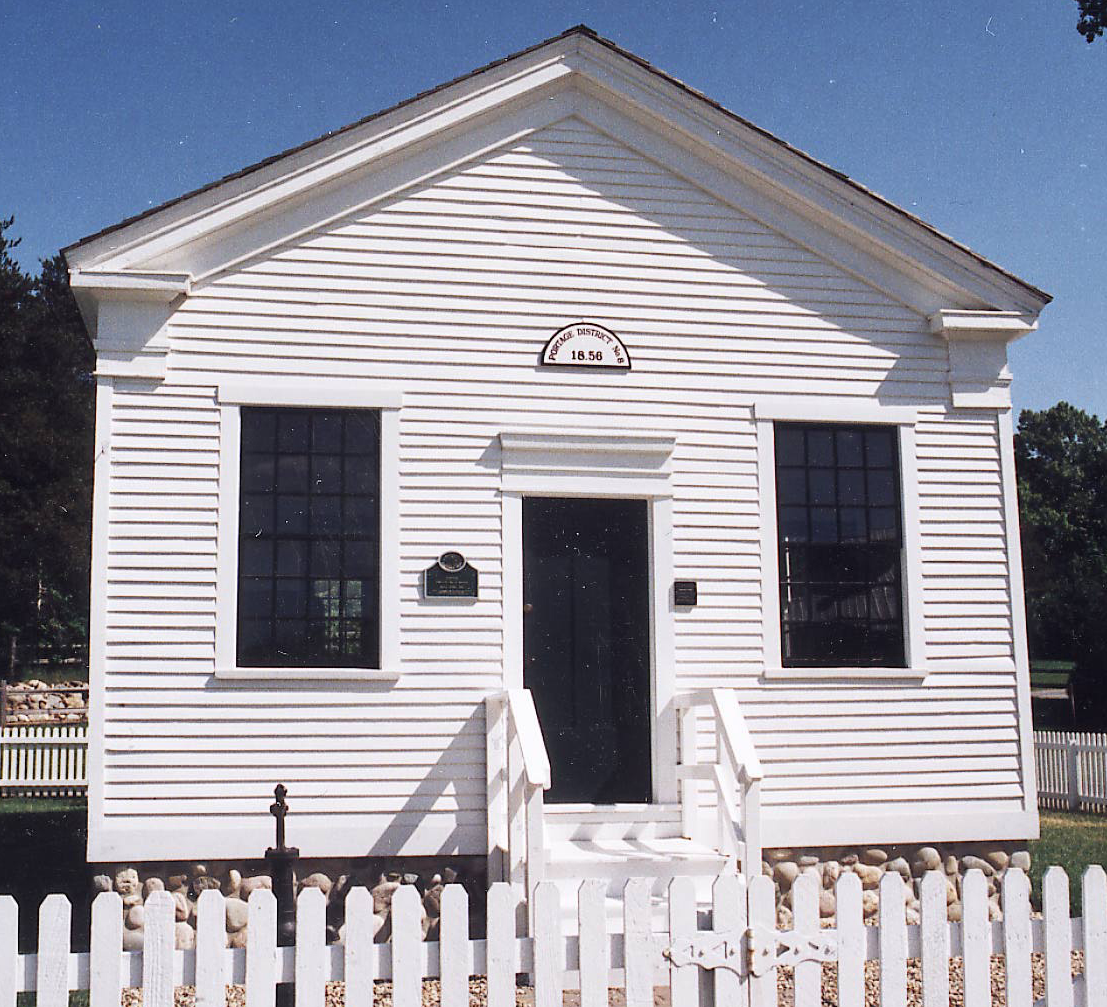 Schoolhouse entrance with a picket fence